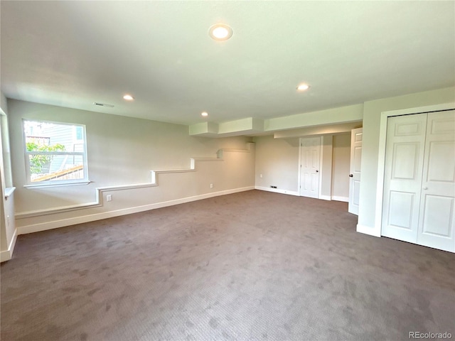 unfurnished bedroom featuring dark carpet