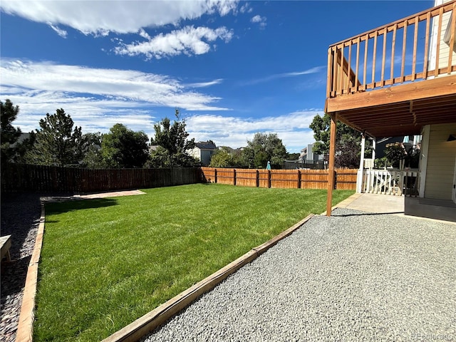 view of yard featuring a deck and a patio area