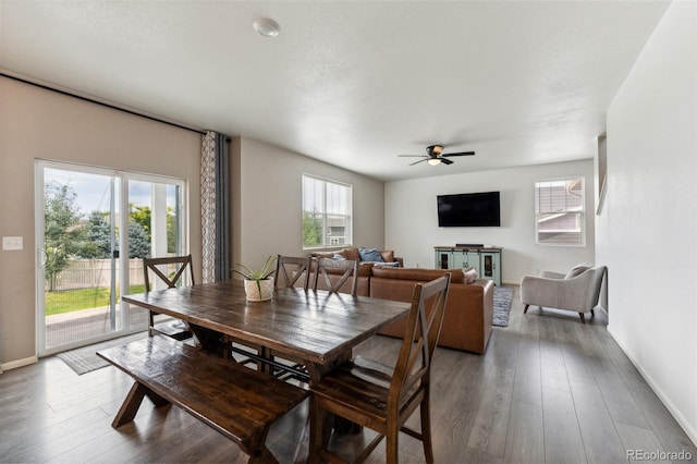 dining area featuring a ceiling fan, baseboards, and hardwood / wood-style floors