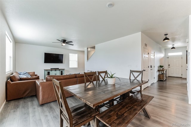 dining space with light wood-style floors and ceiling fan