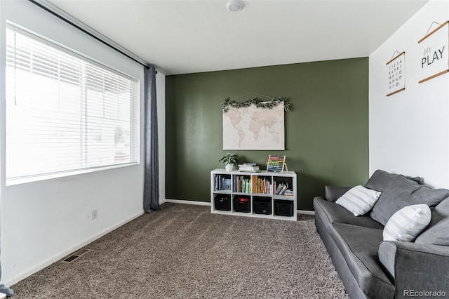 living area featuring carpet, visible vents, and baseboards