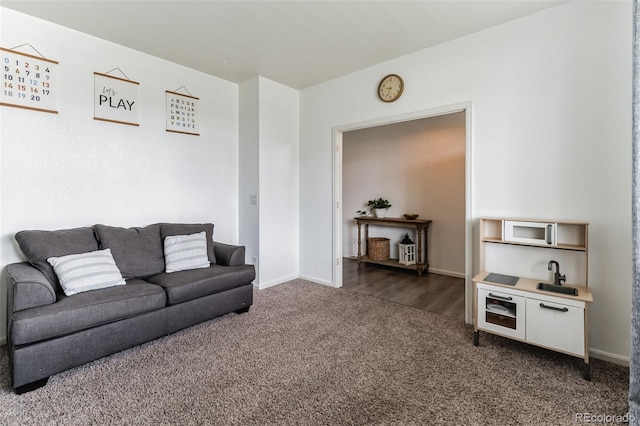 living room featuring dark carpet and baseboards