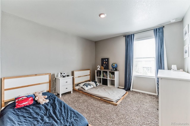 bedroom with carpet floors and baseboards