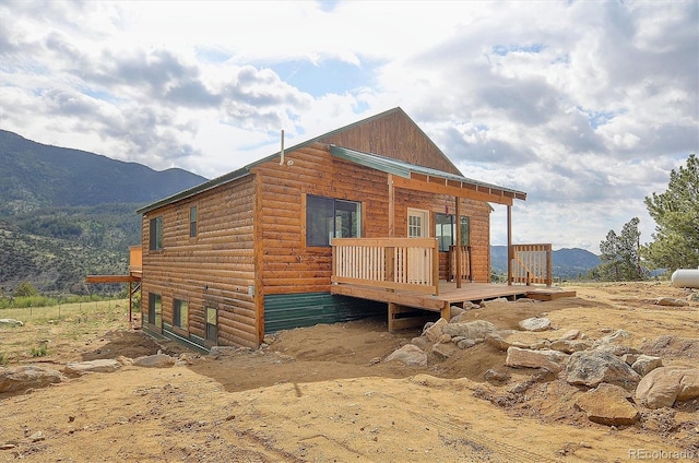 18340 S Lake Rd, Buena Vista, CO 81211 - view of front facade featuring log veneer siding and a deck with mountain view