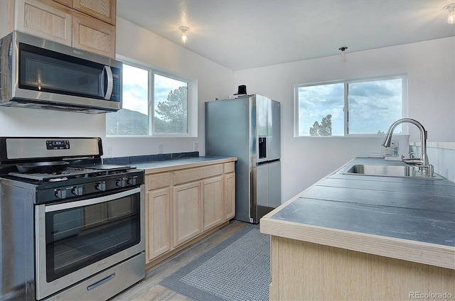 18340 S Lake Rd, Buena Vista, CO 81211 - kitchen featuring appliances with stainless steel finishes, a sink, light brown cabinets, and light wood-style floors