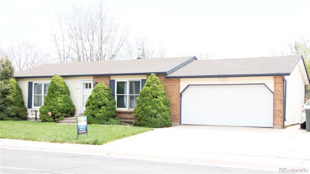 ranch-style home with brick siding, an attached garage, a front yard, and concrete driveway