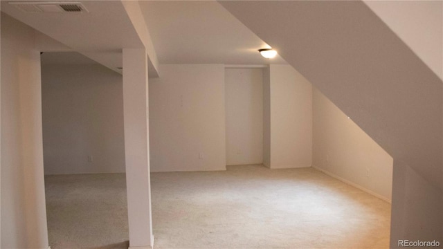 additional living space featuring visible vents and vaulted ceiling