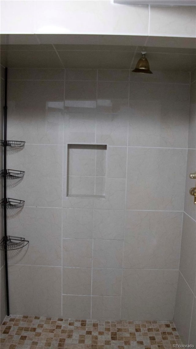 bathroom with tiled shower