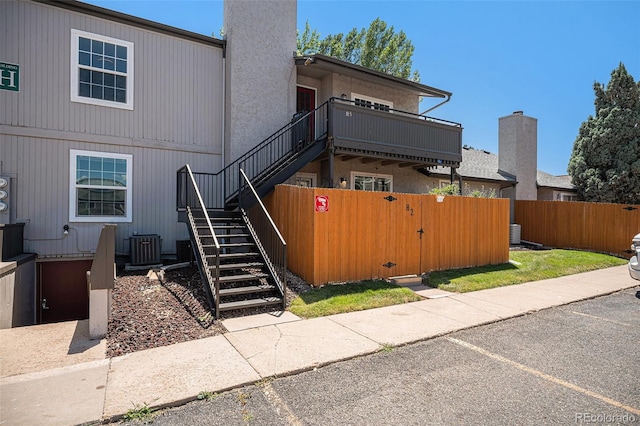 7165 S Gaylord St Unit H05, Centennial, CO 80122 - view of front facade with a gate, stairs, and uncovered parking