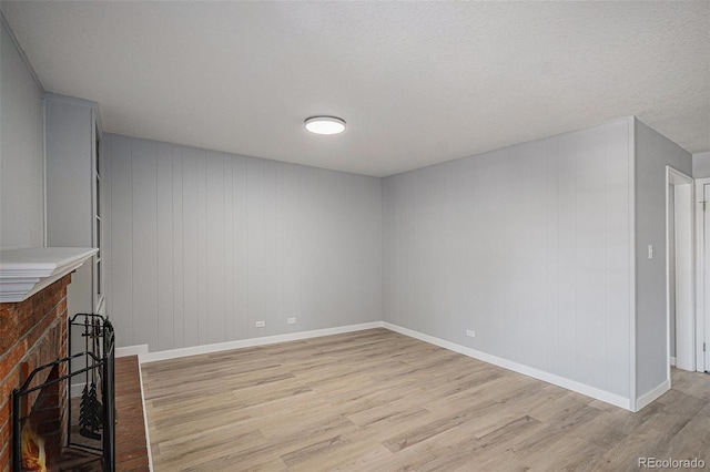7165 S Gaylord St Unit H05, Centennial, CO 80122 - unfurnished living room with light wood-style flooring and baseboards