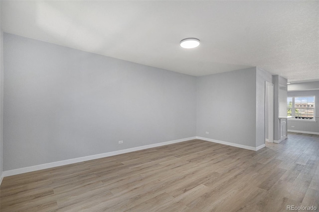 7165 S Gaylord St Unit H05, Centennial, CO 80122 - empty room featuring light wood-type flooring and baseboards