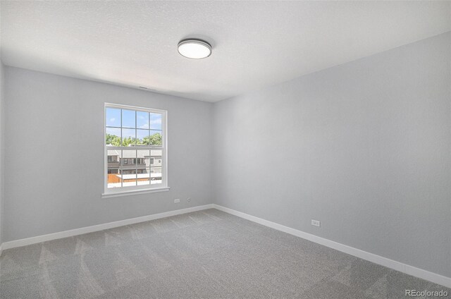 7165 S Gaylord St Unit H05, Centennial, CO 80122 - empty room featuring carpet floors and baseboards