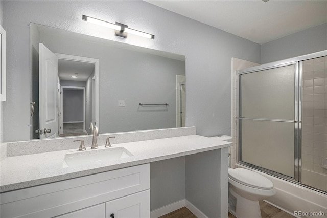 7165 S Gaylord St Unit H05, Centennial, CO 80122 - bathroom with vanity, shower / bath combination with glass door, and wood finished floors
