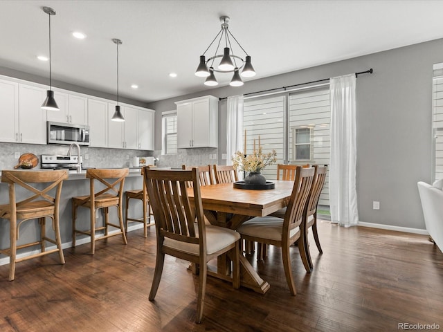 5716 Boston Ct, Denver, CO 80238 - dining area featuring recessed lighting, dark wood finished floors, baseboards, and a chandelier