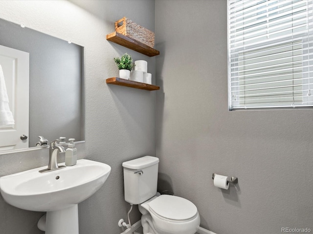 5716 Boston Ct, Denver, CO 80238 - half bath with toilet, a sink, and baseboards