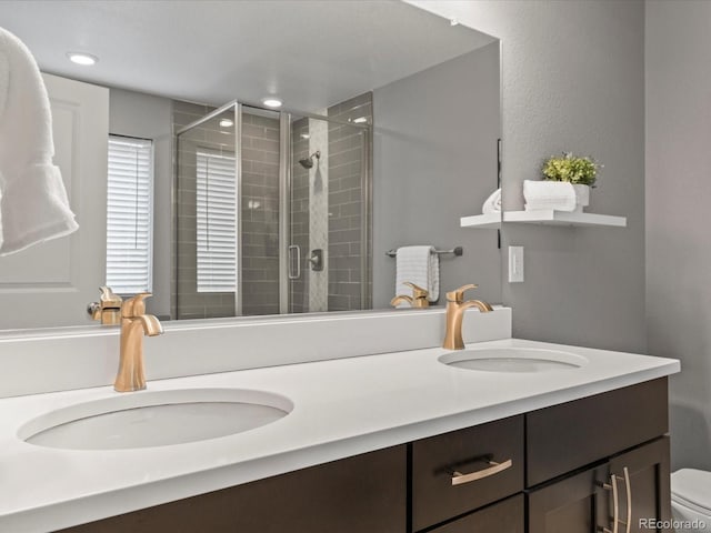 5716 Boston Ct, Denver, CO 80238 - bathroom featuring double vanity, a shower stall, toilet, and recessed lighting