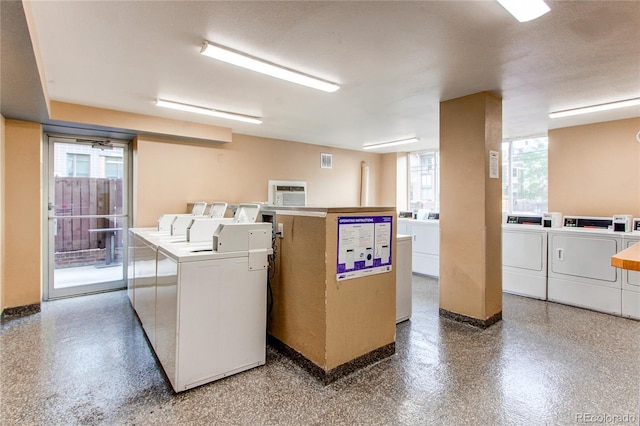 clothes washing area with a wealth of natural light and washer and clothes dryer