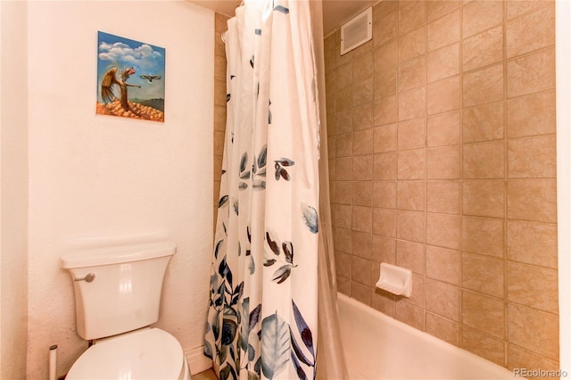 bathroom featuring shower / bath combo and toilet