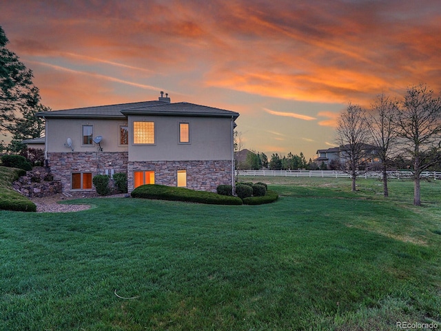 view of side of home featuring stone siding, stucco siding, and a chimney