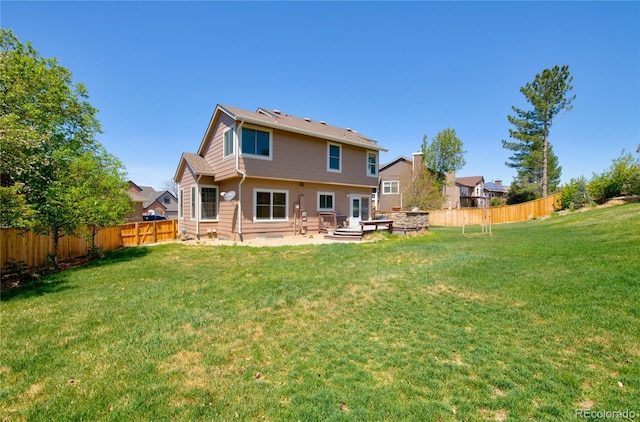 9688 Chesapeake St, Highlands Ranch, CO 80126 - back of house featuring a patio, a fenced backyard, and a yard