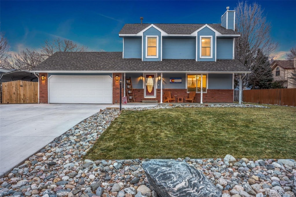 view of front facade featuring a lawn and a garage