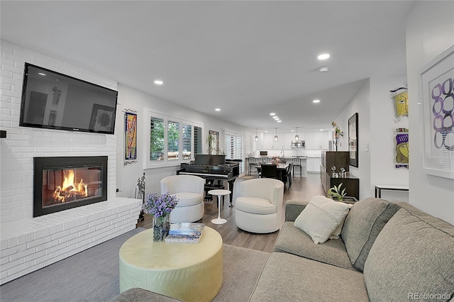 living room with a fireplace and light hardwood / wood-style flooring