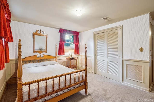 3225 S Race St, Englewood, CO 80113 - bedroom featuring carpet, a closet, a wainscoted wall, and wallpapered walls
