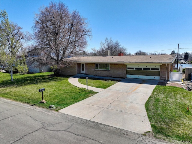 single story home featuring a garage and a front yard