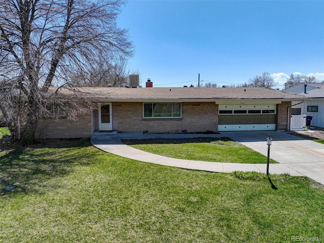 ranch-style home featuring a garage, central air condition unit, and a front yard