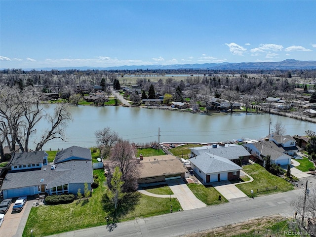 birds eye view of property with a water and mountain view