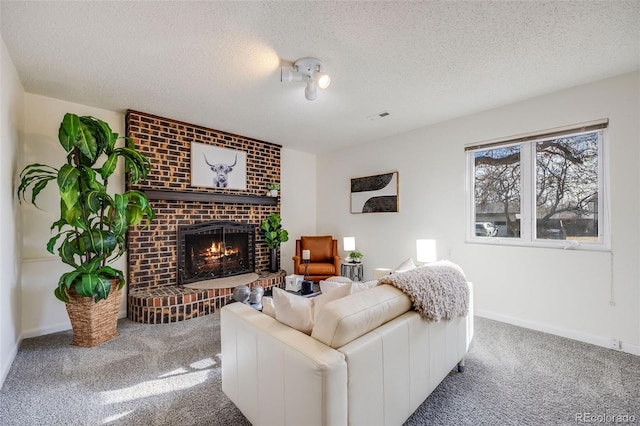 living room with a fireplace, a textured ceiling, and carpet flooring