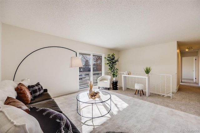 living room with light carpet and a textured ceiling