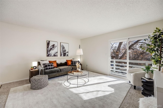 living room with light carpet and a textured ceiling