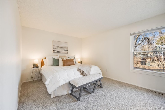 bedroom with carpet flooring and multiple windows