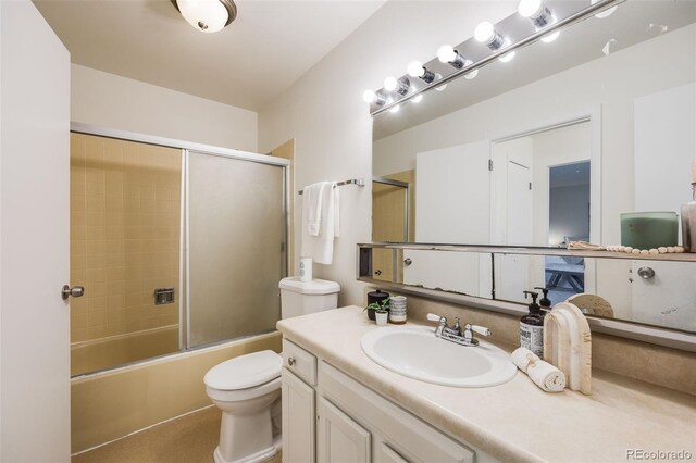 full bathroom featuring vanity, toilet, and enclosed tub / shower combo