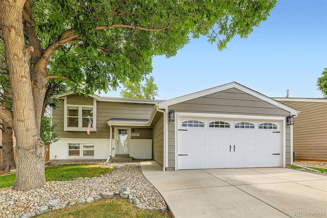 6040 W 75th Dr, Arvada, CO 80003 - view of front facade featuring an attached garage and concrete driveway