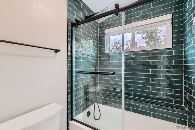 6040 W 75th Dr, Arvada, CO 80003 - bathroom featuring shower / bath combination with glass door and toilet