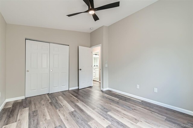 6040 W 75th Dr, Arvada, CO 80003 - unfurnished bedroom featuring wood finished floors, lofted ceiling, a closet, and ceiling fan