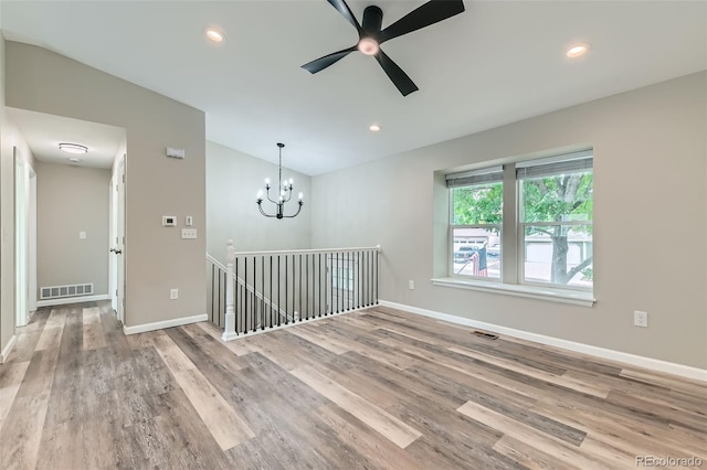 6040 W 75th Dr, Arvada, CO 80003 - empty room with wood finished floors, a chandelier, ceiling fan, and recessed lighting