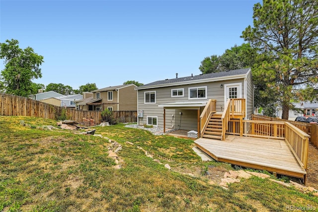 6040 W 75th Dr, Arvada, CO 80003 - back of house featuring a fenced backyard and a wooden deck