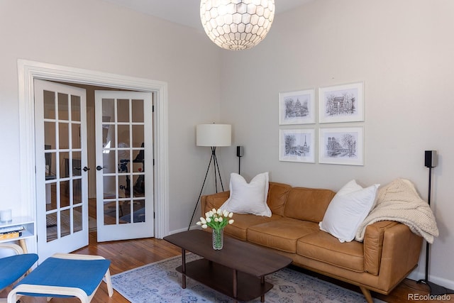 living room featuring baseboards, french doors, and wood finished floors