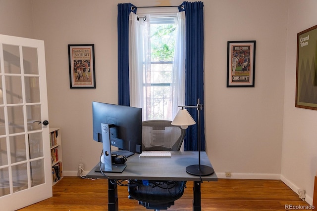 office space with baseboards and wood finished floors