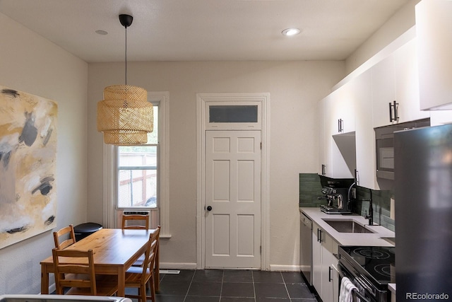 kitchen featuring freestanding refrigerator, range with electric cooktop, white cabinetry, and dishwasher