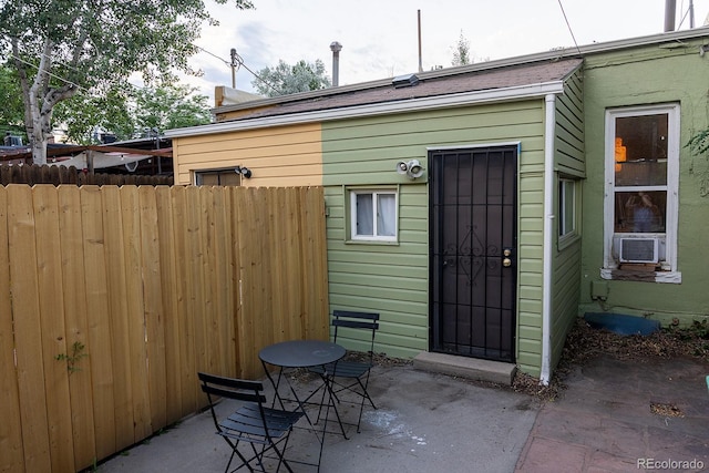 view of outdoor structure featuring fence and cooling unit