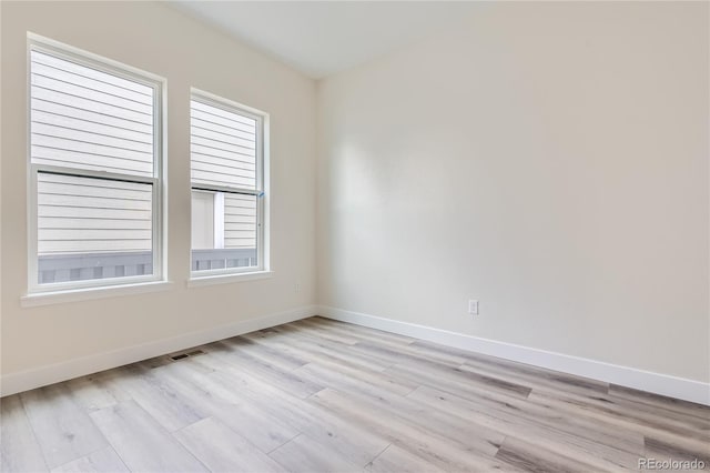 unfurnished room with light hardwood / wood-style floors