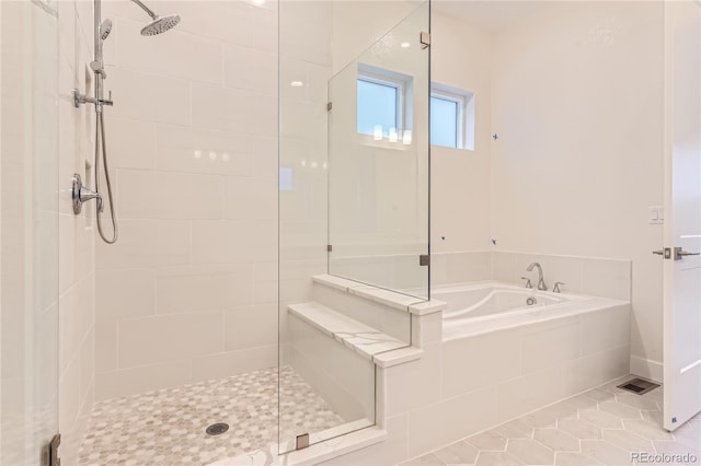 bathroom featuring tile patterned flooring and plus walk in shower