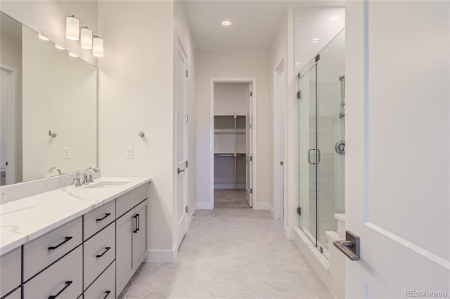 bathroom featuring vanity, tile patterned floors, and a shower with door