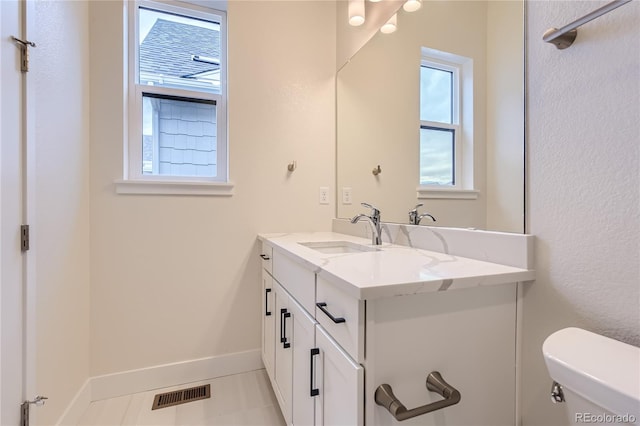 bathroom with tile patterned floors, vanity, and toilet