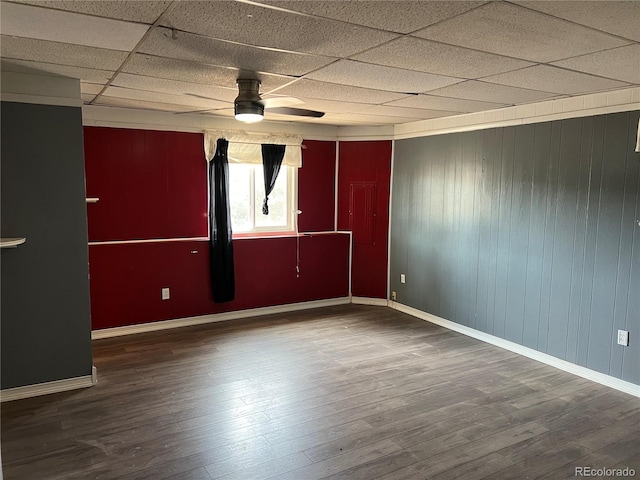 empty room featuring ceiling fan, a paneled ceiling, and wood-type flooring