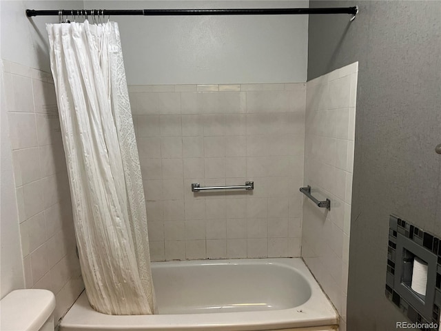 bathroom with shower / tub combo and toilet